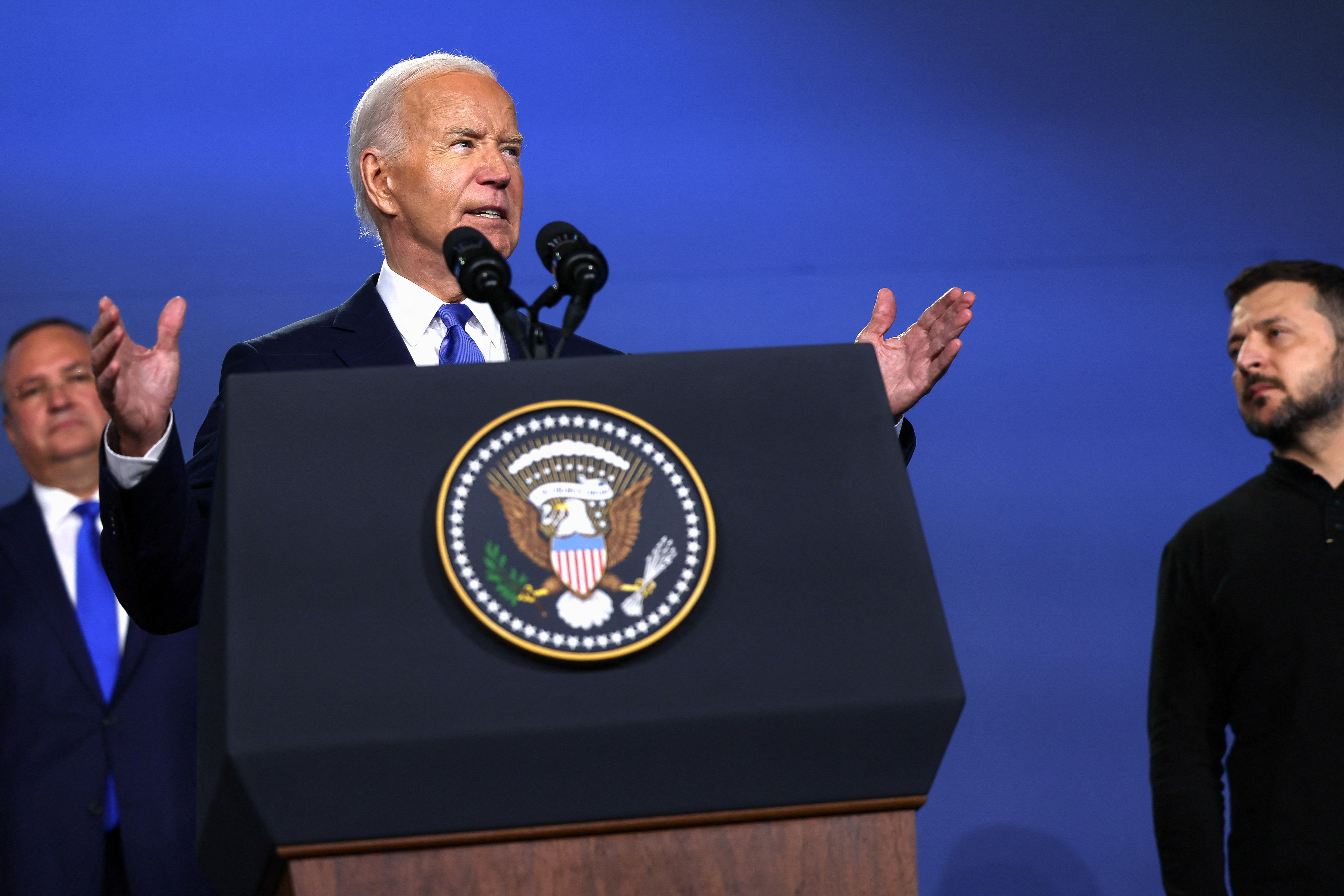 Biden speaks at a podium with a US seal.