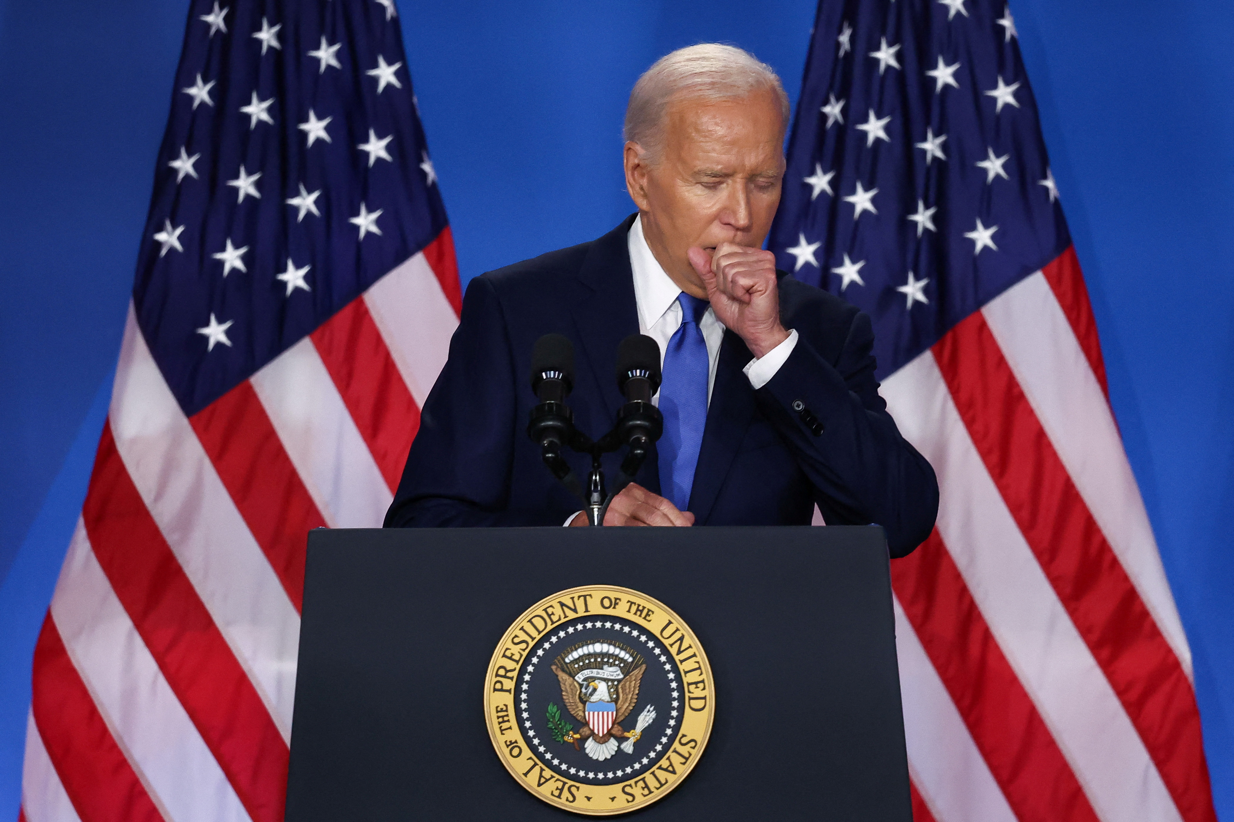 Biden clears his throat at podium.