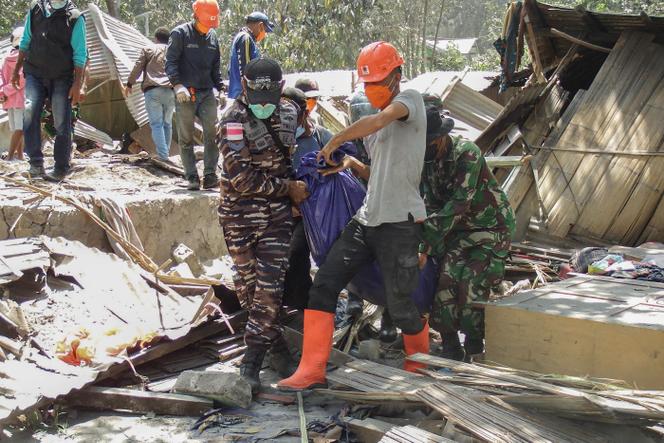 Members of a rescue team carry away body bags containing deceased people in Klatanlo village, East Nusa Tenggara, after Mount Lewotobi Laki-Laki erupted overnight on November 4, 2024. 