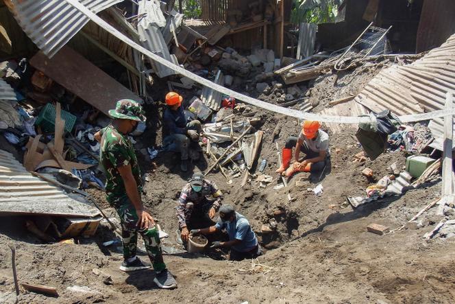 Members of a rescue team search for victims in Klatanlo village, East Nusa Tenggara, after the Lewotobi Laki-Laki volcano erupted overnight on November 4, 2024. 