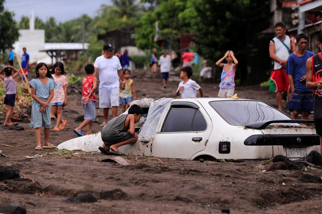 A car buried by volcanic ash swept away by heavy rains caused by Typhoon Trami, south of Manila, October 23, 2024.