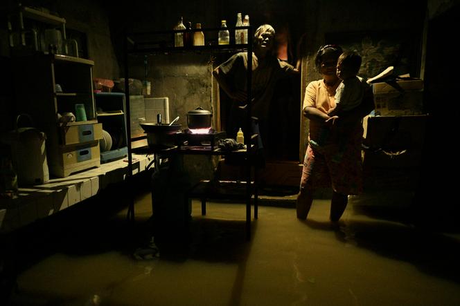 Residents in their flooded homes after Typhoon Yinxing swept through the town of Buguey, in the northern province of Cagayan, on November 8, 2024.