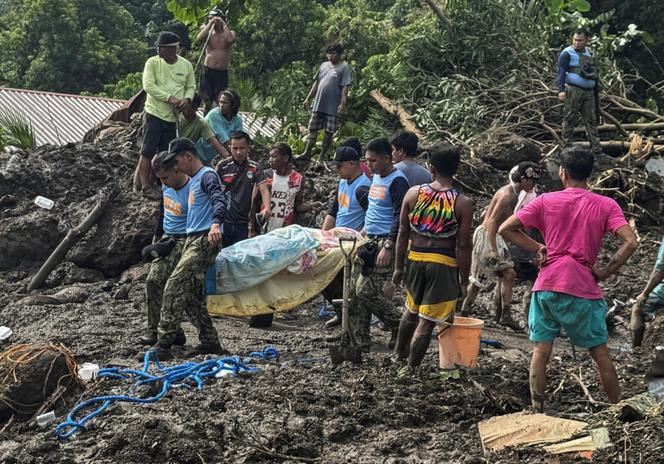 Rescue workers carry a landslide victim in Batangas province on October 25, 2024.