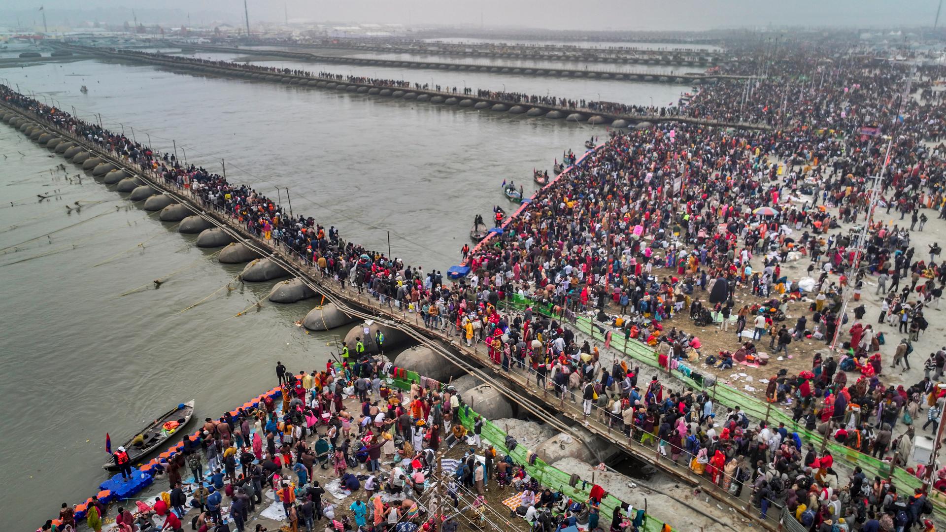 Hindu faithful cross a pontoon in Sangam, the confluence of the Ganges, the Yamuna and the legendary Saraswati, the day of Makar Sankranti, during the Maha Kumbh festival, in the Uttar Pradesh, in India, on Tuesday January 14, 2025.