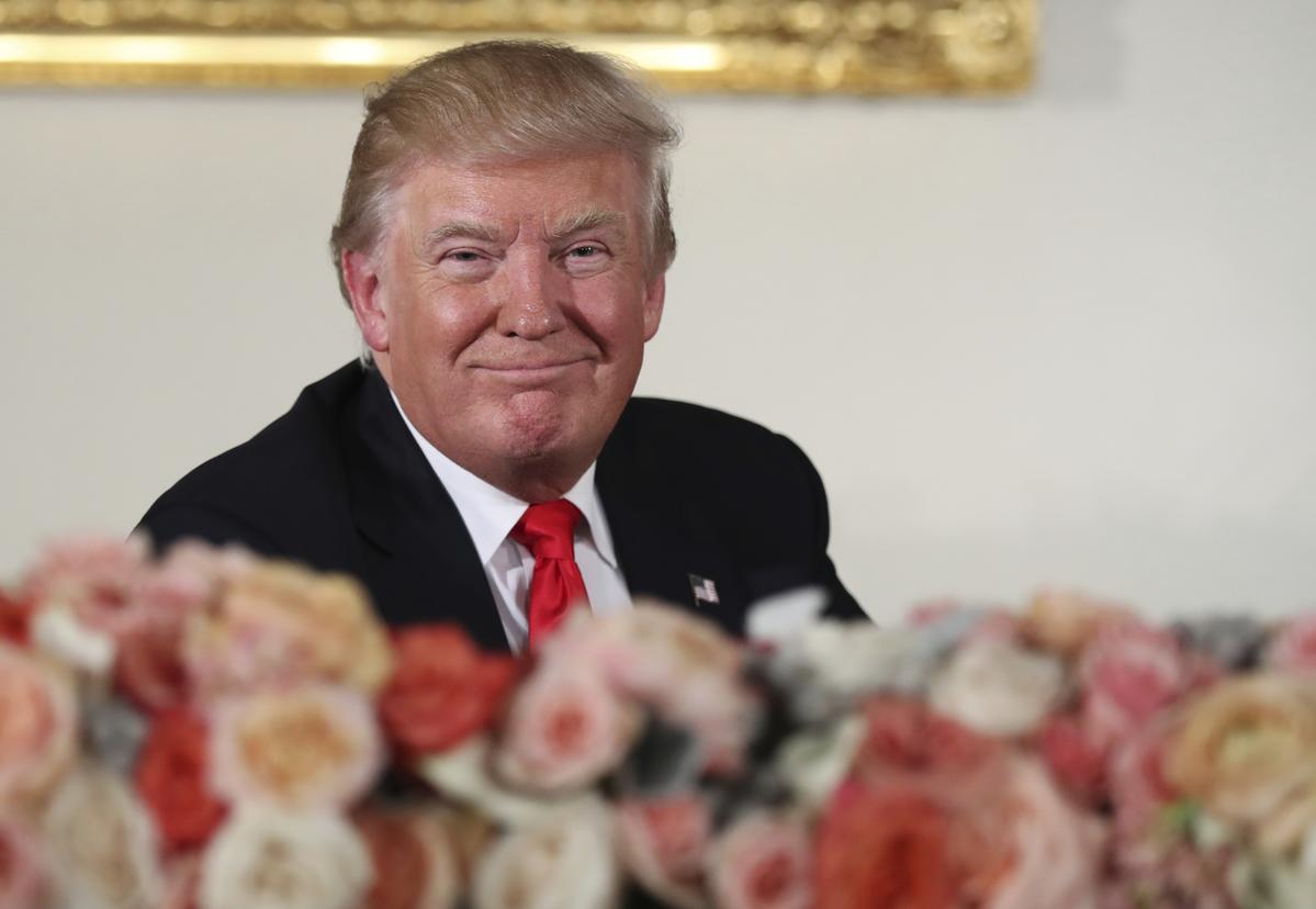 President Donald Trump smiles during the inaugural luncheon in 2017.