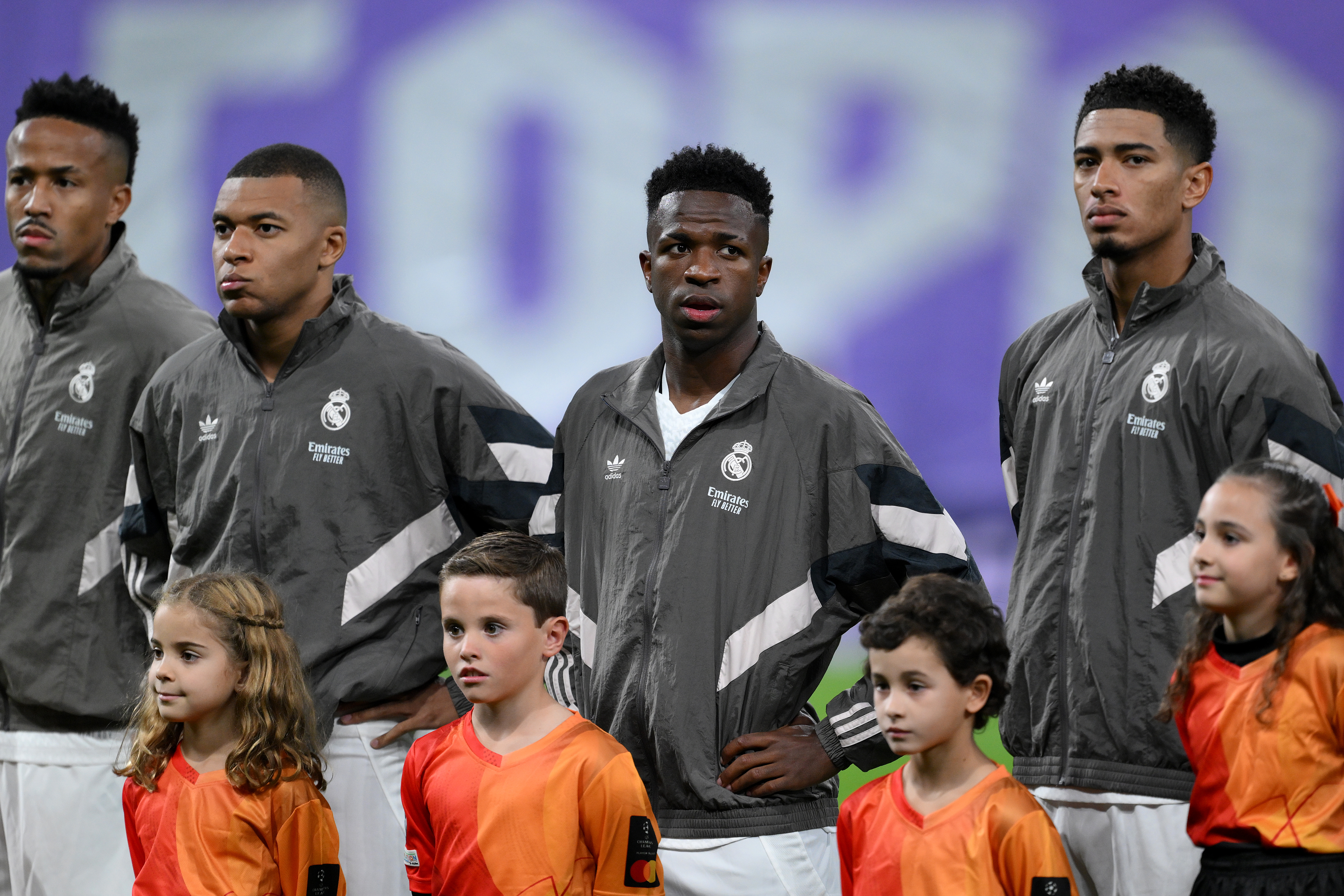 MADRID, SPAIN - OCTOBER 22: Eder Militao, Kylian Mbappe, Vinicius Junior and Jude Bellingham of Real Madrid watch on prior to the UEFA Champions League 2024/25 League Phase MD3 match between Real Madrid C.F. and Borussia Dortmund at Estadio Santiago Bernabeu on October 22, 2024 in Madrid, Spain. (Photo by David Ramos/Getty Images)